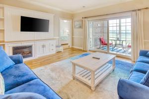 a living room with a blue couch and a table at Palmetto Retreat in Myrtle Beach