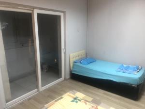 een kleine slaapkamer met een bed en een glazen deur bij AVRUPA APART HOSTEL in Seyhan