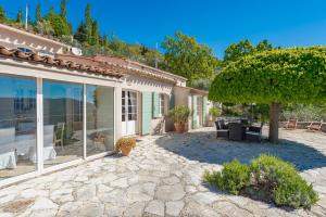 a patio in front of a house with a tree at romantique villa provencale in Bargemon