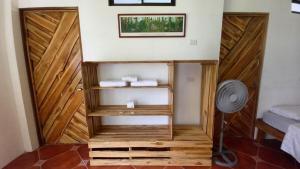 a room with wooden doors and a fan at Hotel Pura Natura Beachfront Tortuguero in Tortuguero