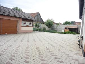 a driveway in front of a building with a garage at Ubytovanie v súkromí 85 suterén in Bešeňová