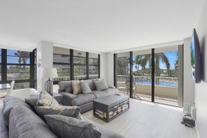 a living room with a couch and a tv in it at South Seas Tower 4-206 in Marco Island