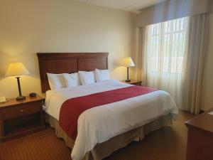 ein Hotelzimmer mit einem großen Bett und einem Fenster in der Unterkunft Penn Wells Lodge in Wellsboro