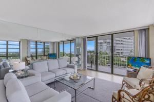 a living room with white furniture and large windows at South Seas Tower 3-411 in Marco Island