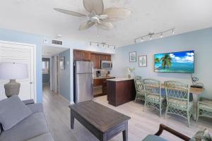 a living room with a kitchen and a dining room at Apollo 304 in Marco Island