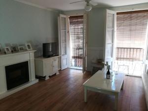 a living room with a fireplace and a tv at Reus, cosy apartment in the city's centre in Reus