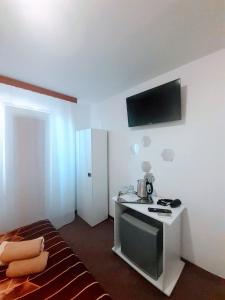 a room with a bed and a tv on a wall at Vila Atipic in Costinesti +37 photos