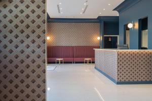 a lobby with a bar and a red bench at Hotel Mary in Vico Equense