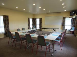 a conference room with a table and chairs and a whiteboard at Valdez Motor Lodge in Hastings +36 photos