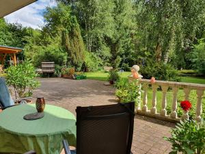 a patio with a table and a fence at Ferienwohnung Haus Sonnenschein in Trassem +8 photos