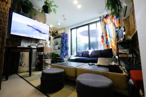 a living room with a couch and a tv at Plage Yuigahama in Kamakura