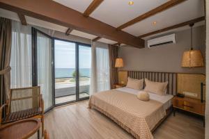 a bedroom with a bed with a view of the ocean at Villa Siesta Hotel Istanbul Airport in Karaburun