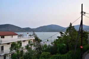 a view of a building and a body of water at Nana's house in Chalkida