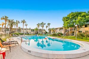 a swimming pool at a resort with palm trees at Sea Palms in Fort Walton Beach