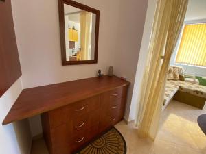 a bathroom with a wooden dresser and a mirror at Studios in Complex Colosseum in Kranevo +22 photos