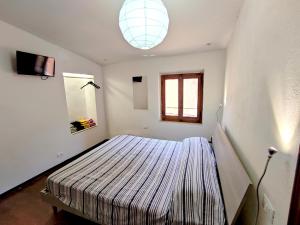 a bedroom with a bed in the corner of a room at Casa via della Rocca Luna in Poggibonsi