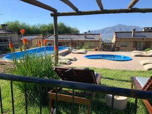 a backyard with a swimming pool and a playground at Los Carolinos by DOT Cabana in Tafí del Valle