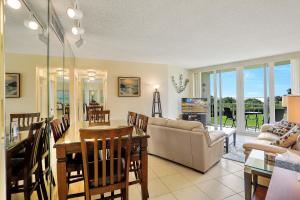 a living room with a couch and a table at Cozy beachfront condo with pool and tennis courts in Marco Island