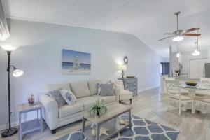 a living room with a white couch and a table at Charming condo with two pools and steps to beach in Marco Island