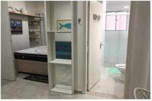 a room with a bedroom with a bed and a bathroom at Apto com Wi-Fi bem perto da praia em Santos SP in Santos