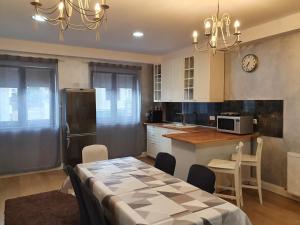 a kitchen with a table and a dining room at French Boutique in Braşov