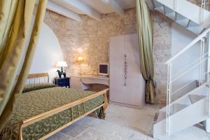 a bedroom with a bed and a staircase in a room at Le Alcove - Luxury Hotel nei Trulli in Alberobello