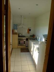 a kitchen with a sink and a refrigerator at Brīvdienu māja Lejas in Pope