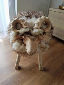 a stuffed animalanimal with legs on a wooden floor at Galeria Apartments - Jasná in Demanovska Dolina