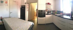 a kitchen with a refrigerator and a table in it at Ulm 2-room Apartment near university & city Centre in Ulm