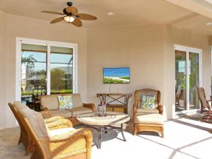 a living room with a couch and chairs and a table at Waterfront home with pool, spa and boating access in Marco Island