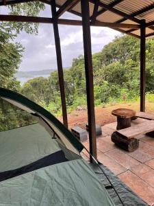 a tent sitting on a patio with a picnic table at Jungle Eco Reserve in Colón