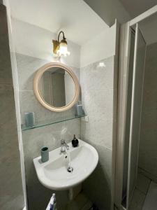 a bathroom with a sink and a mirror at Celeste Apartment in Genoa