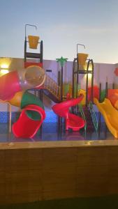 a childrens playground with a slide and a play area at شاليه كاردڤ1 in Al Baha