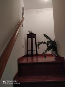 een trap met een houten kruk en een plant bij Marechiaro Home Holiday in Vico Equense