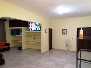a living room with a flat screen tv on the wall at Huasteco, tu casa en valles! in Ciudad Valles