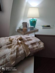 a bedroom with a bed with a bow on it at Marechiaro Home Holiday in Vico Equense +2 photos