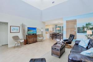 Μια τηλεόραση ή/και κέντρο ψυχαγωγίας στο Florida-style home with pool and steps to beach