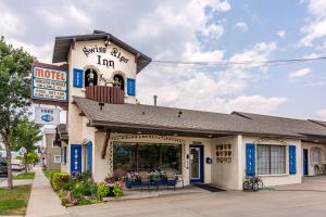 a building with a sign that reads sushi alley inn at Swiss Alps Inn in Heber City