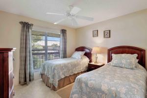 a bedroom with two beds and a window at Inland condo with pool and steps to beach/food/shops in Marco Island +18 photos