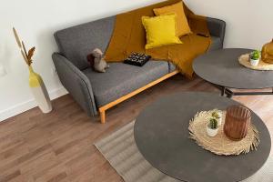 a living room with a couch and two tables at Le Poulorio 5 - Proche Gare By Locly in Lorient
