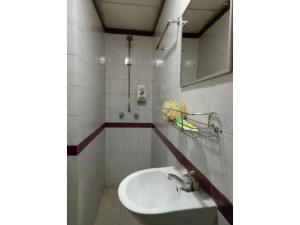 a bathroom with a sink and a mirror at TS Hotel - Taman Rinting in Masai
