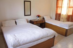 En eller flere senge i et værelse på Hotel Gainda Island Camp