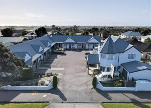 an aerial view of a house with a parking lot at ASURE Gables Motor Lodge in Greymouth