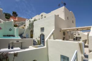 a cluster of white buildings in a town at Timedrops Santorini Villas-Private pool in Emporio