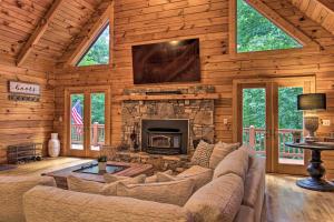 a living room with a couch and a fireplace at 7 Mi to Ski Slopes Mars Hill Cabin with Hot Tub! in Mars Hill
