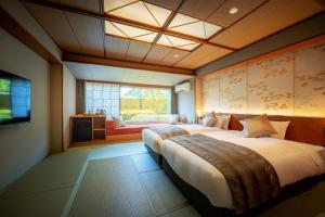 sypialnia z dużym łóżkiem i oknem w obiekcie Eirakukan w mieście Kōriyama