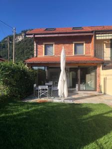 a large white umbrella in front of a house at LUXURY vertical open space in Sangiano