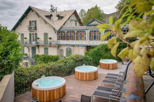 a house with three circular tables in front of it at Belfry & Spa by Ligne St Barth in Lourdes