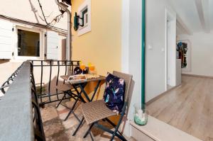 a balcony with two chairs and a table at Yellow House Rovinj in Rovinj