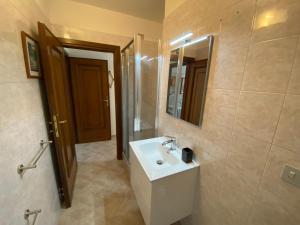 a bathroom with a white sink and a mirror at Appartamenti Borgo San Pietro in Deiva Marina